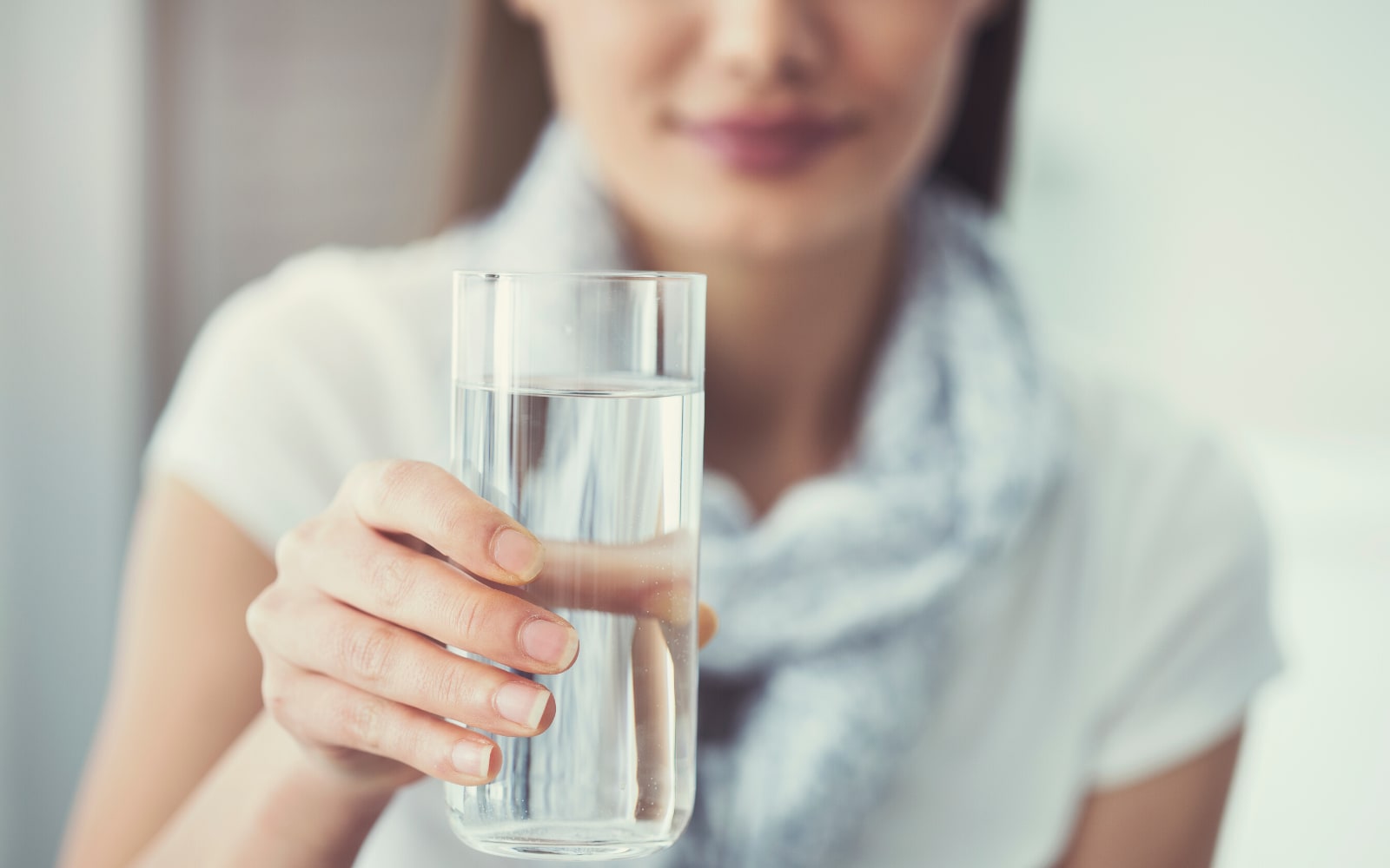 Persons handing over a glass of water.
